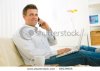 stock-photo-casual-businessman-working-at-home-sitting-on-couch-using-laptop-computer-talking-on.jpg